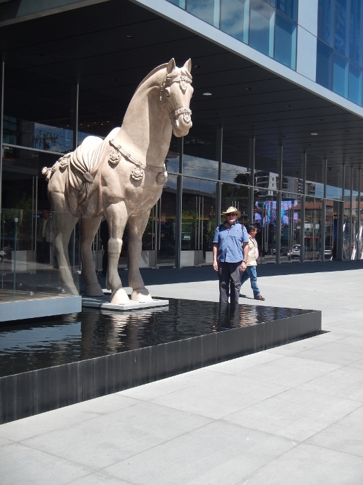 2017 Guat City Brian stands in front of a statue of a horse