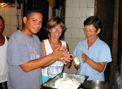Anthony the base
        cooks shows the girls how to cook arepas
