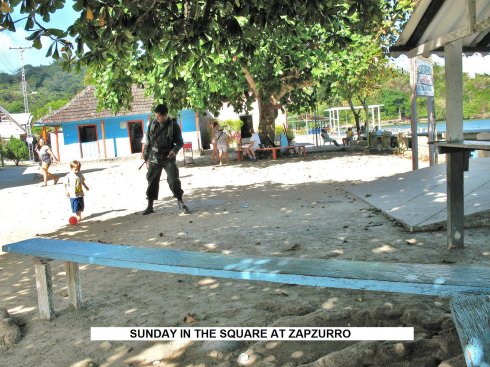 Our Guard playing
        with children in the square Zapzurro