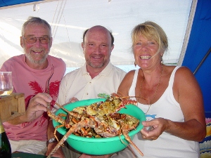 Adrian left, Friend
            middle, Christine right enjoying a lobster feed at the
            Tobago Keys 2005