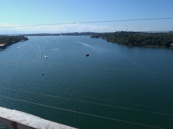 View looking west from
              the top of the bridge that crosses the Rio Dulce