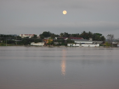 The full moon sets over
        the town of Flores as viewed from our balcony