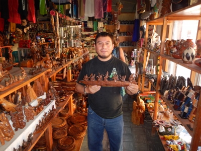 The carver artist holding his carving of the five Mayan
        Gods that took him days to complete