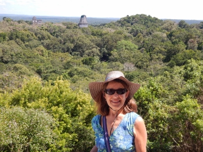 Behind Kathy is the view from our vantage point on Monument
        four in Tikal National Park