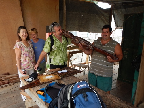 Carlos the Carpenter proudly
        shows us his carving of an Caiman