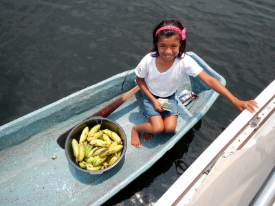 A native girl makes a sale in Burnt Cay
        Harbour