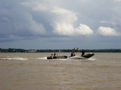 Local fishermen
            wave as they pass us in the Orinoco River Venezuela