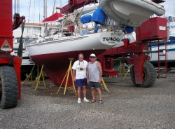 Bob and Brian
                beside refurbished Tundra in the boat yard at Bahia
                Redonda