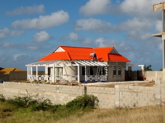 Frank and
          Hennies almost completed home built on a knoll overlooking our
          anchorage