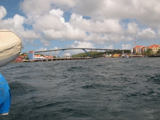 The Pontoon Bridge at
        Willemsted closes behind as Tundra departs the harbour