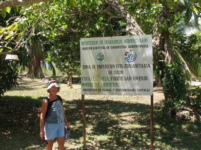 Kathy poses by the entrance sign to Fort Lorenzo