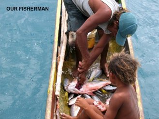 Andrubin and son Robelito clean our daily catch of
        fish