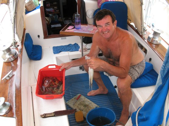 Brian with sea
        food bought at Green Island