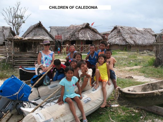 Kathy poses with
        some of the children of Caledonia