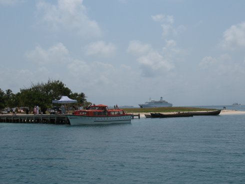 The original
        Loveboat cruise ship lies off Porvenir bringing in mola
        shoppers
