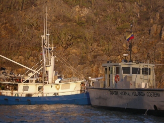 Willie and Mary
        aboard Twilight talk to Venezuelan Coast Guard after anchoring
        in Chimanda Segunda